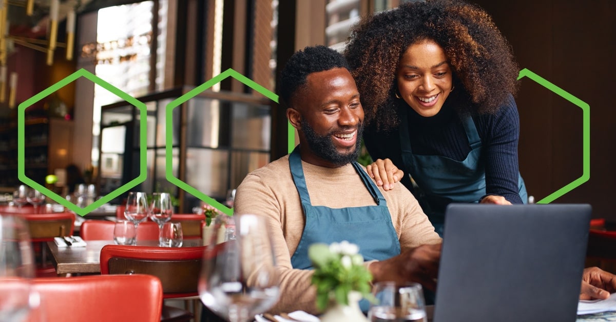 Man and woman looking at a laptop screen