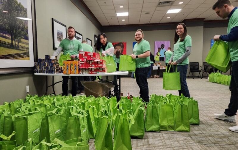 Huntington colleagues assembling food bags