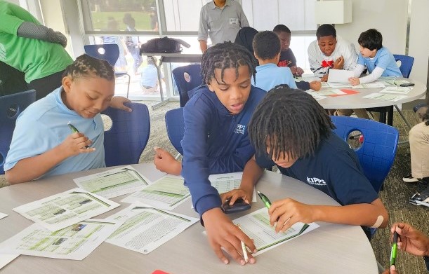 Students collaborating with each other around a table