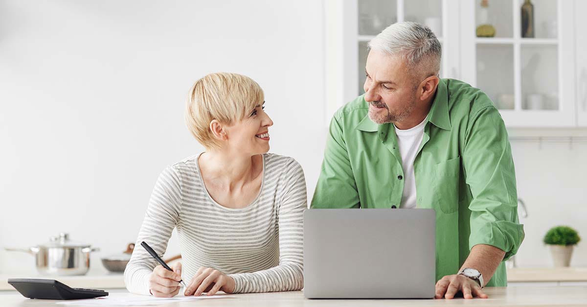 Woman and man looking at laptop screen